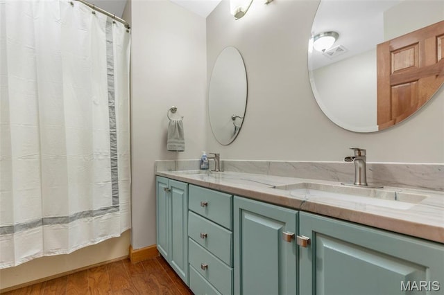 2453 Lone Trail Dr, Foristell, MO 63348 - bathroom with wood finished floors, double vanity, and shower / bath combo with shower curtain