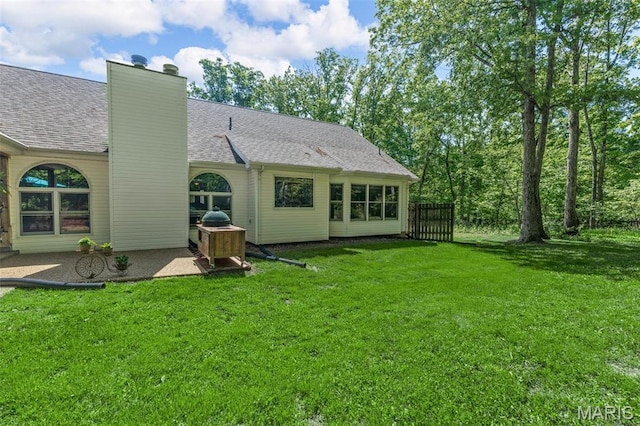 2453 Lone Trail Dr, Foristell, MO 63348 - rear view of property with a yard, a chimney, a shingled roof, and a patio area