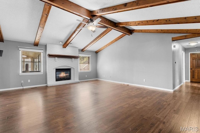 unfurnished living room featuring a ceiling fan, wood finished floors, baseboards, and a fireplace