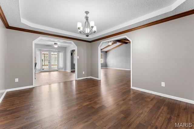unfurnished room featuring arched walkways, ceiling fan, a chandelier, a tray ceiling, and a textured ceiling