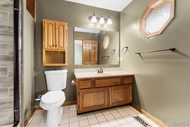 bathroom featuring tile patterned floors, toilet, vanity, and baseboards