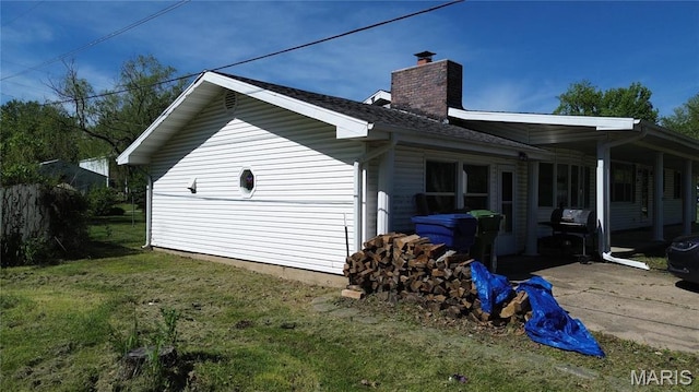 120 E Beth St, Licking, MO 65542 - view of side of home with a chimney, a yard, a patio area, and a shingled roof