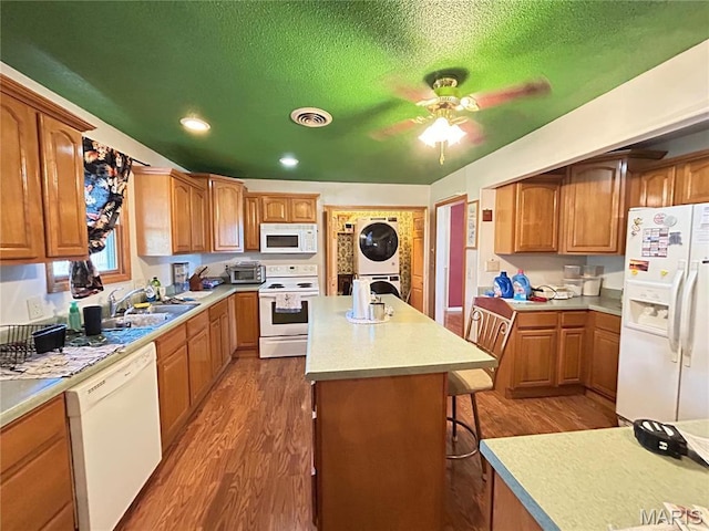 120 E Beth St, Licking, MO 65542 - kitchen featuring white appliances, stacked washing machine and dryer, dark wood finished floors, a ceiling fan, and a textured ceiling