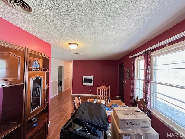120 E Beth St, Licking, MO 65542 - dining space featuring a textured ceiling, wood finished floors, and baseboards