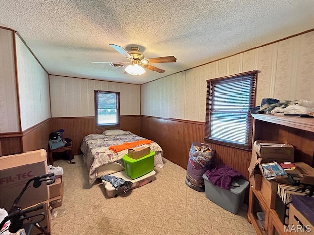 120 E Beth St, Licking, MO 65542 - bedroom featuring a wainscoted wall, a textured ceiling, ceiling fan, wooden walls, and ornamental molding