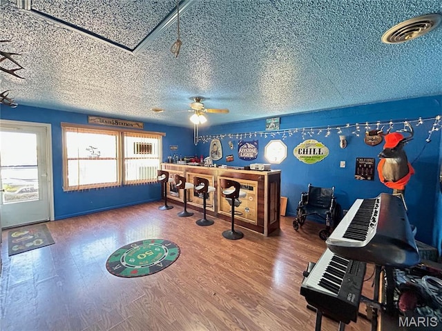 120 E Beth St, Licking, MO 65542 - home office with a ceiling fan, wood finished floors, a textured ceiling, attic access, and a bar
