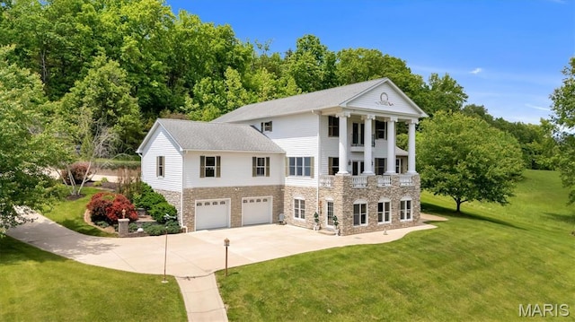 590 Fairway Dr, Union, MO 63084 - view of front of property with stone siding, driveway, an attached garage, and a front yard