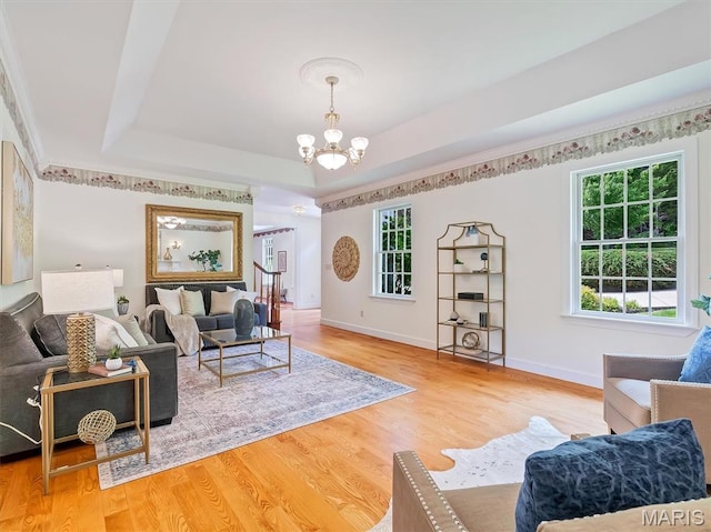 590 Fairway Dr, Union, MO 63084 - living room with a chandelier, healthy amount of natural light, wood finished floors, and a tray ceiling