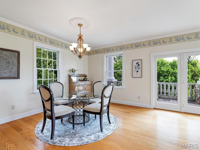590 Fairway Dr, Union, MO 63084 - dining space with a chandelier, plenty of natural light, light wood-style flooring, baseboards, and ornamental molding