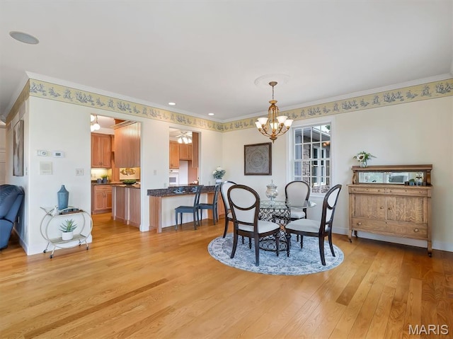 590 Fairway Dr, Union, MO 63084 - dining area with ornamental molding, a chandelier, light wood finished floors, and baseboards