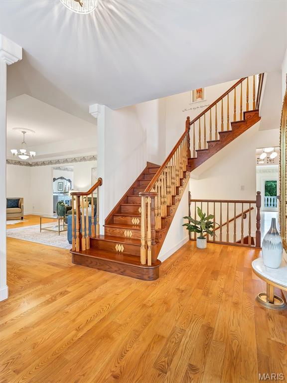 590 Fairway Dr, Union, MO 63084 - stairway featuring wood finished floors, baseboards, and a chandelier