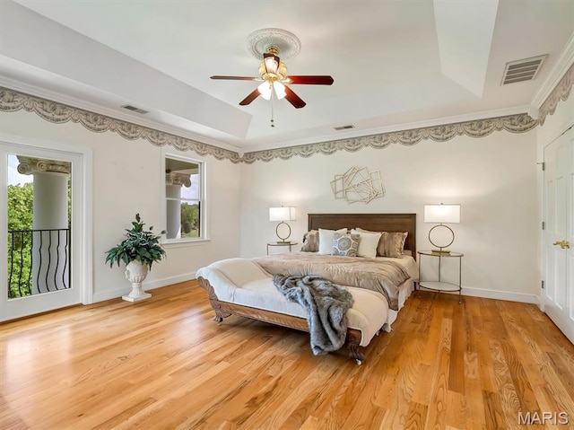 590 Fairway Dr, Union, MO 63084 - bedroom featuring a raised ceiling, light wood-style floors, baseboards, and access to outside