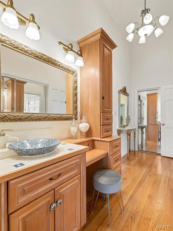 590 Fairway Dr, Union, MO 63084 - bathroom featuring a chandelier, wood finished floors, and vanity