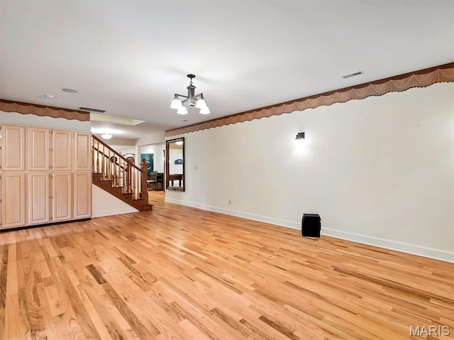 590 Fairway Dr, Union, MO 63084 - unfurnished living room featuring light wood-style floors, a chandelier, stairway, and baseboards