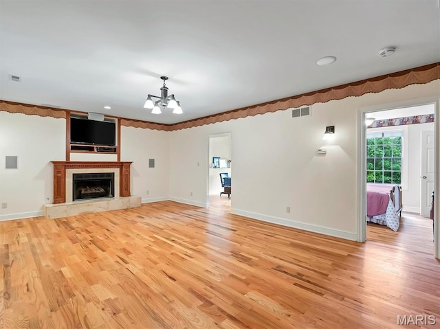 590 Fairway Dr, Union, MO 63084 - unfurnished living room featuring a chandelier, light wood-style flooring, baseboards, a high end fireplace, and recessed lighting