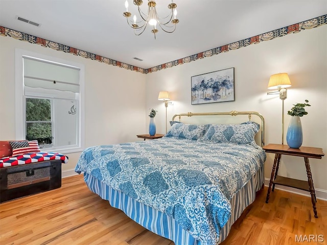 590 Fairway Dr, Union, MO 63084 - bedroom featuring wood finished floors, a chandelier, and baseboards