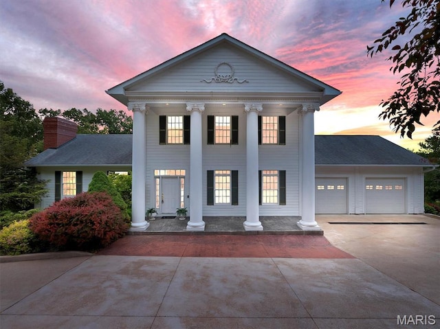 590 Fairway Dr, Union, MO 63084 - greek revival inspired property featuring a porch, driveway, an attached garage, and a chimney