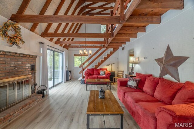 87 E Altdorf Dr, Innsbrook, MO 63390 - living room with stairs, wood finished floors, high vaulted ceiling, beamed ceiling, and a fireplace
