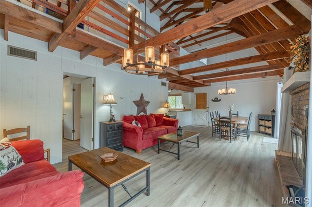 87 E Altdorf Dr, Innsbrook, MO 63390 - living area with a chandelier, a glass covered fireplace, and wood finished floors