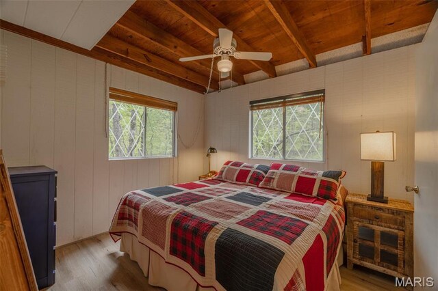 87 E Altdorf Dr, Innsbrook, MO 63390 - bedroom with wood finished floors, wooden ceiling with exposed beams, a ceiling fan, and wooden walls