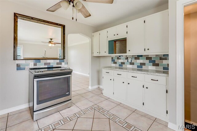 kitchen featuring electric range, a ceiling fan, decorative backsplash, and light tile patterned floors