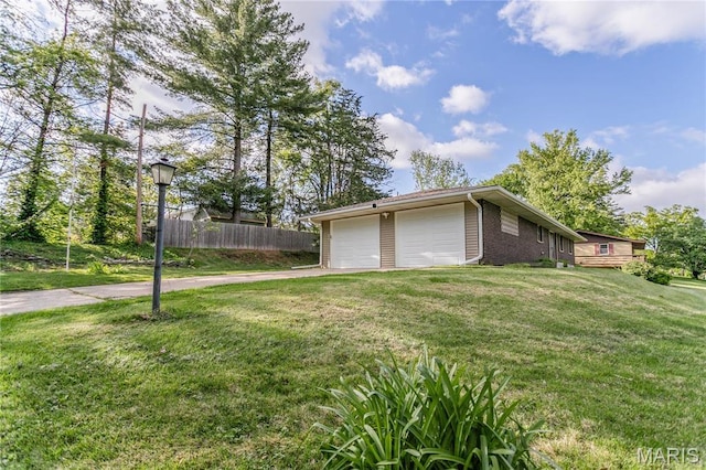 4900 Eiffel Dr, Godfrey, IL 62035 - view of side of home with a garage, concrete driveway, and brick siding
