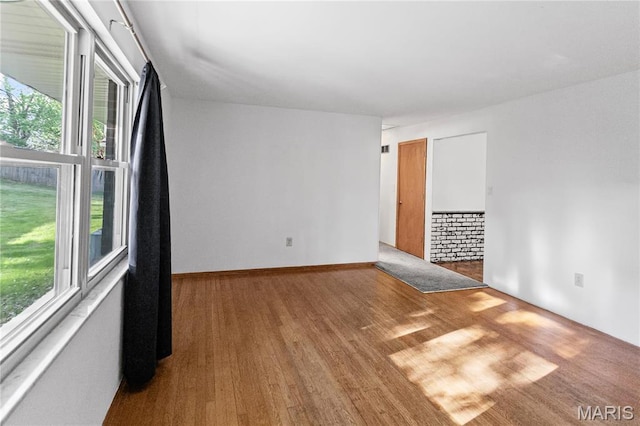 4900 Eiffel Dr, Godfrey, IL 62035 - empty room featuring plenty of natural light and wood finished floors