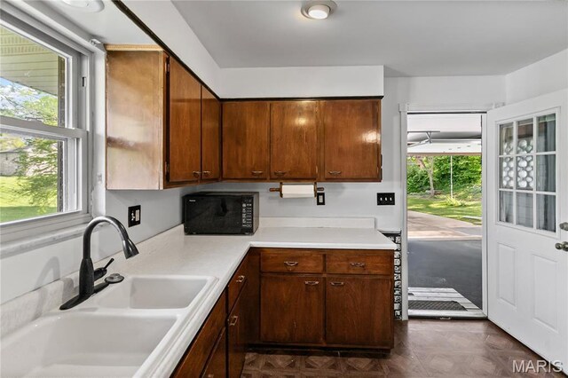 4900 Eiffel Dr, Godfrey, IL 62035 - kitchen featuring a sink, black microwave, and light countertops