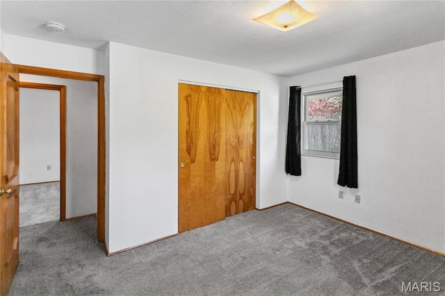 4900 Eiffel Dr, Godfrey, IL 62035 - unfurnished bedroom with carpet flooring, a closet, and baseboards
