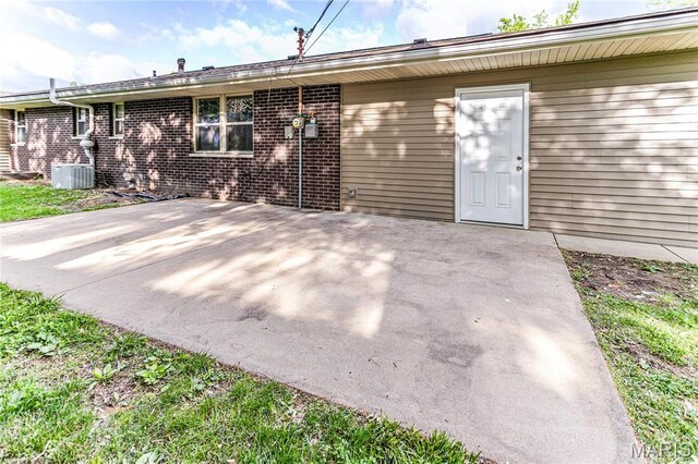 4900 Eiffel Dr, Godfrey, IL 62035 - rear view of house featuring a patio, brick siding, and cooling unit