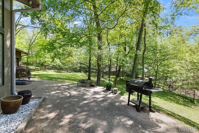 view of home's community featuring a patio and a lawn
