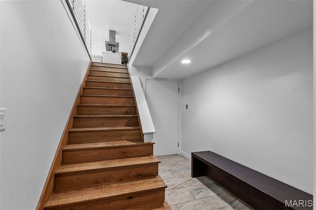 stairs with recessed lighting and baseboards