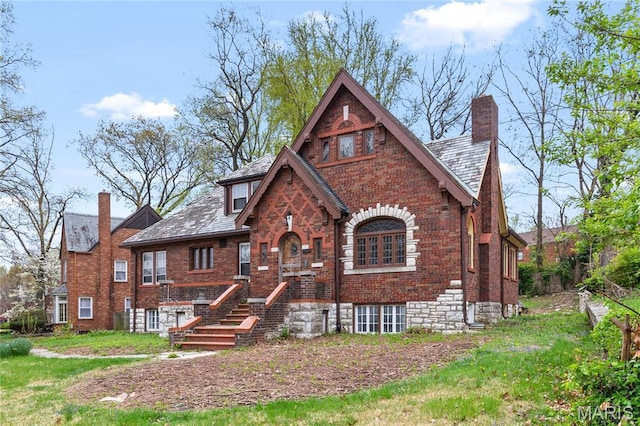 7280 S Roland Blvd, Saint Louis, MO 63121 - tudor home with a chimney, brick siding, and a high end roof
