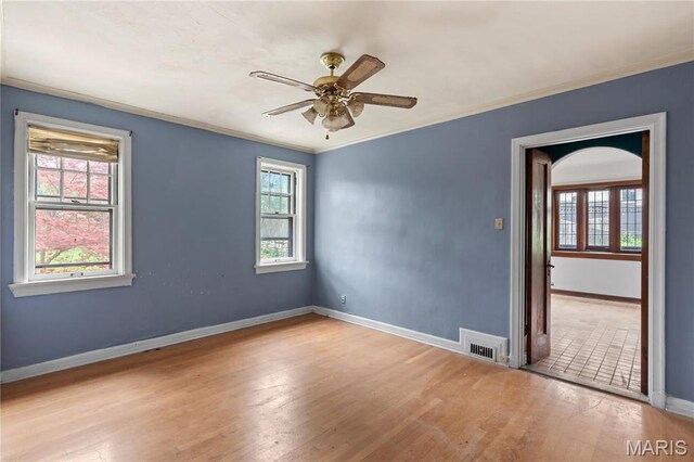 7280 S Roland Blvd, Saint Louis, MO 63121 - unfurnished room featuring crown molding, ceiling fan, baseboards, and wood finished floors