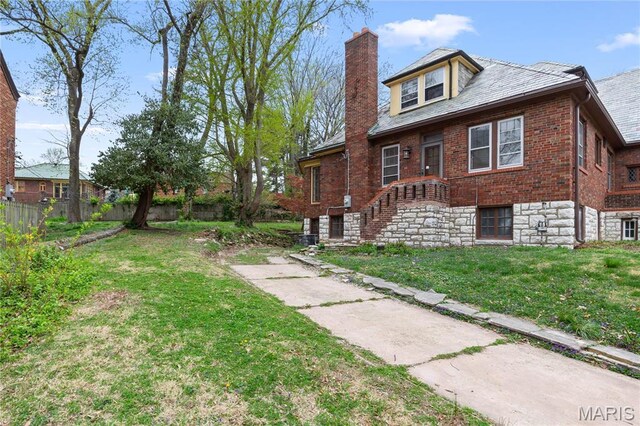 7280 S Roland Blvd, Saint Louis, MO 63121 - view of side of property featuring a chimney, a high end roof, and brick siding
