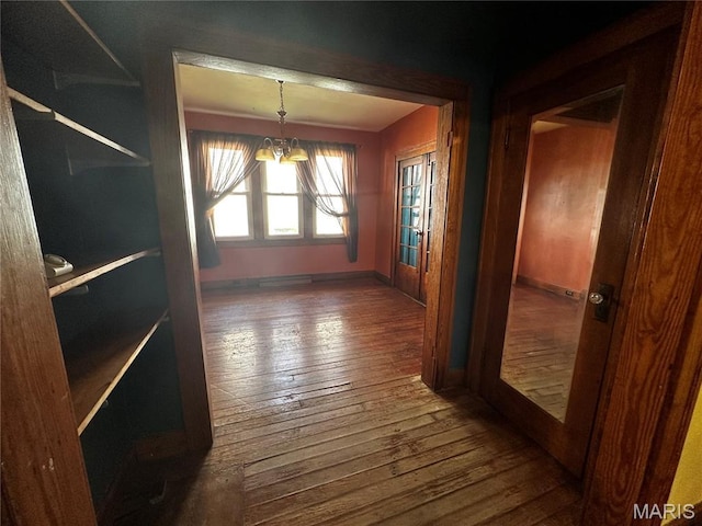 1323 Union Ave, Belleville, IL 62220 - unfurnished dining area featuring wood-type flooring, baseboards, and a chandelier