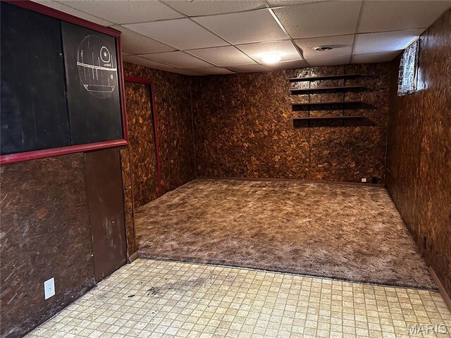 1323 Union Ave, Belleville, IL 62220 - finished basement with a paneled ceiling, wood walls, tile patterned floors, and carpet
