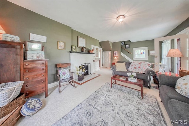 carpeted living room with a brick fireplace