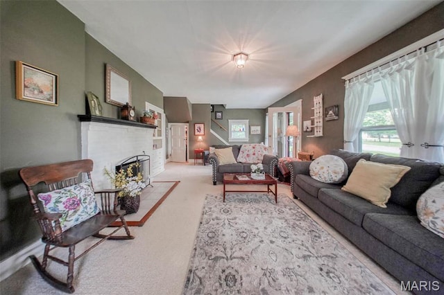 living area with carpet flooring and a fireplace