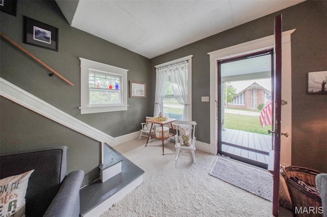 carpeted foyer entrance featuring baseboards