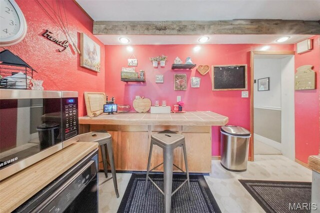 indoor bar with stainless steel microwave and recessed lighting