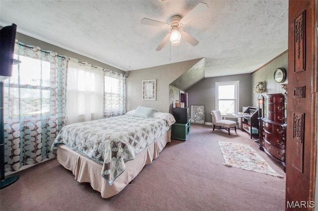 carpeted bedroom with a textured ceiling and ceiling fan