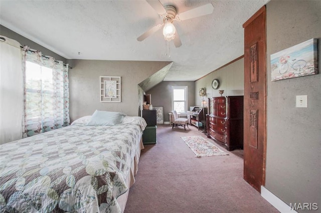 carpeted bedroom with a textured ceiling, ceiling fan, and a textured wall