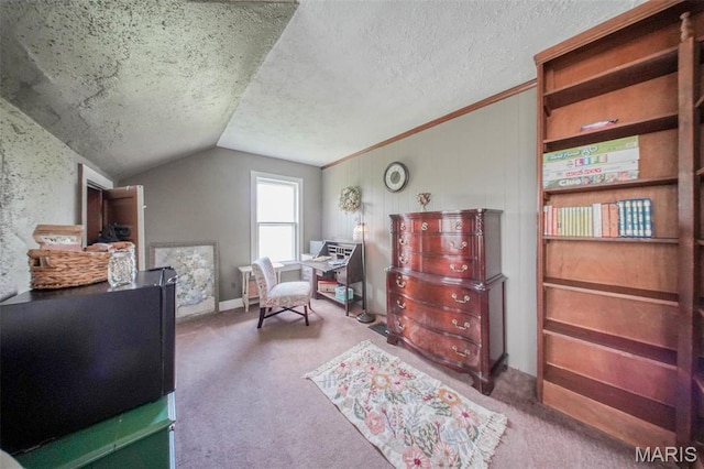 carpeted bedroom featuring vaulted ceiling and a textured ceiling