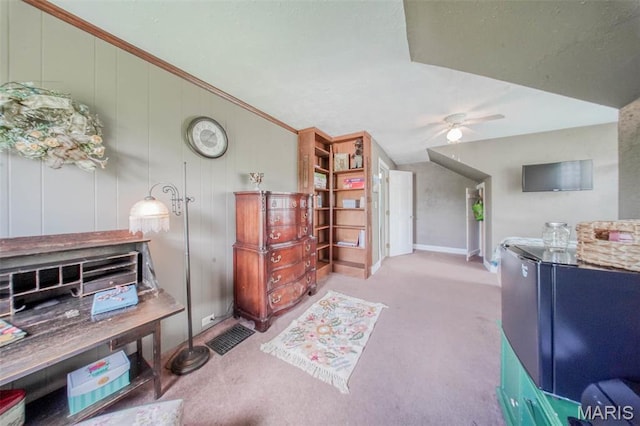 office area featuring carpet floors, a ceiling fan, and crown molding
