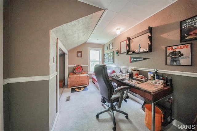 carpeted office space featuring lofted ceiling