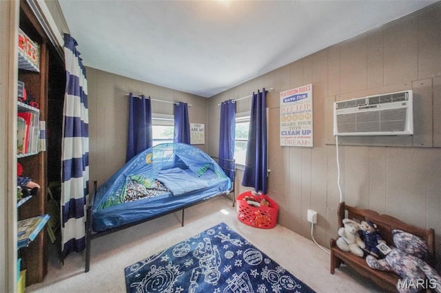 bedroom featuring carpet floors and an AC wall unit