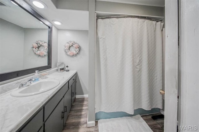 bathroom with wood finished floors, vanity, baseboards, recessed lighting, and a shower with shower curtain