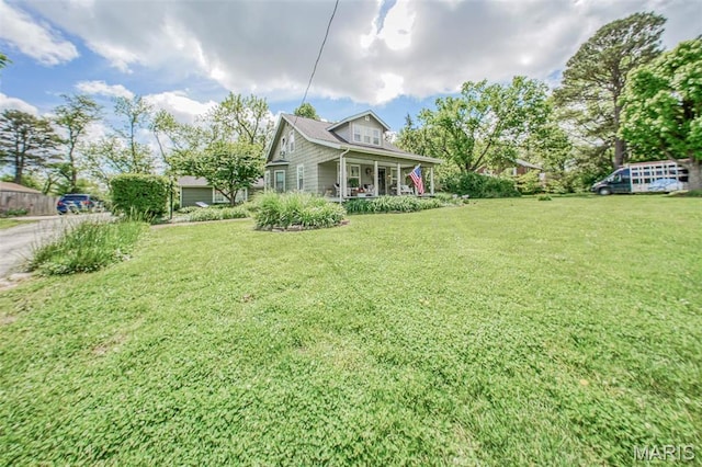 view of grassy yard featuring a porch