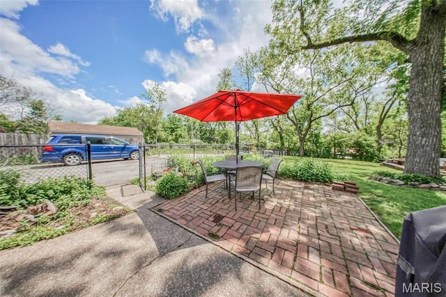 view of patio featuring fence and outdoor dining space